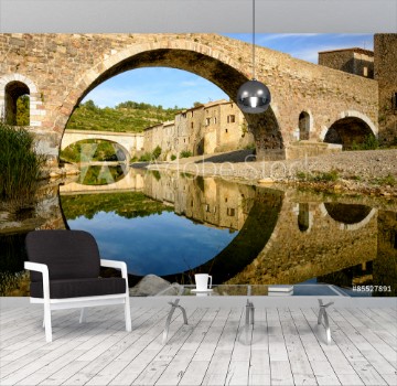 Bild på Reflection and symmetry with a medieval bridge in Lagrasse